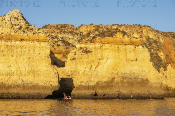 Stand-up paddler at Ponta de Piedade, Lagos, Algarve, Portugal, Europe