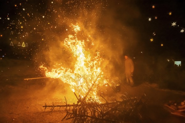 Christmas tree burning on the Kleinnauendorf fairground. The local history association G-Haus invited people to a fiery spectacle to part with their old Christmas trees. What was particularly remarkable was the fact that there were very quickly burning specimens and, in turn, almost unburnable ones, Kleinnauendorf, Saxony, Germany, Europe