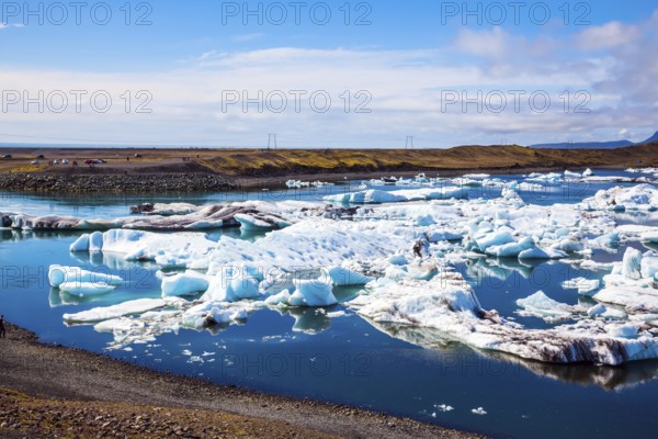 White-blue ice is piled up in turquoise water of Jokulsarlon. The concept of extreme northern tourism