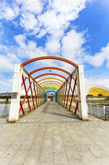 Magnificent light bridge over the river Aviles. The picturesque town of Avilas in Asturias. North of Spain. International cultural center of the famous architect Oscar Niemeyer
