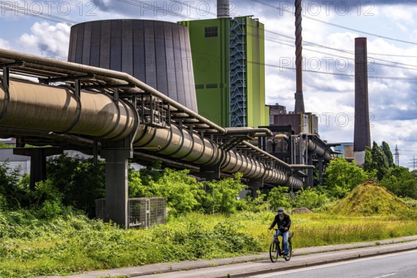 Pipelines for various gases, blast furnace gas, Thyssenkrupp Steel steelworks in Duisburg-Bruckhausen, in front the gas-fired Hamborn power station, green façade of boiler house Block5, North Rhine-Westphalia, Germany