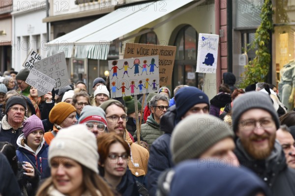 Heidelberg, Germany - February 12th 2025: Person holding up sign showing drawing of people of color in crowd at protest against far-right