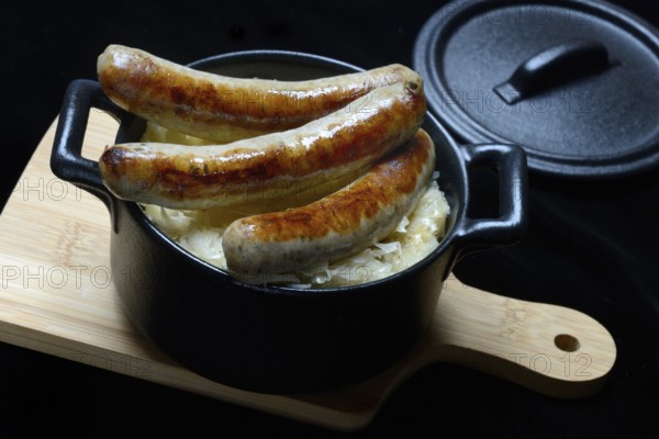 Nuremberg sausages with sauerkraut in a pot, Rostbratwurst, Germany