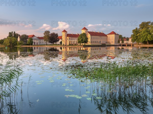 Rheinsberg Castle on Lake Lake Grienerick in the last evening light, Rheinsberg, Brandenburg, Germany