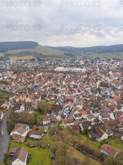 Aerial view of a town with red tiled roofs and surrounding hills on a cloudy day, Großbottwar, Ludwigsburg district, Baden-Württemberg, Germany