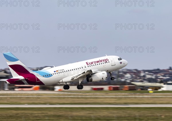 Stuttgart Airport STR EDDS. Manfred Rommel Airport. Eurowings aircraft taking off. Airbus A319-100 with dynamic motion blur. Stuttgart, Baden-Württemberg, Germany