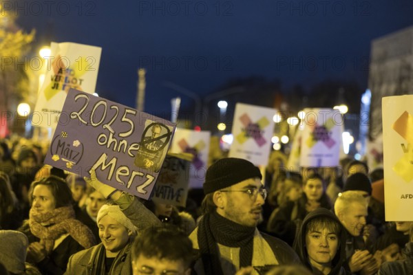 Participants with signs 2025 without Merz and AfD ban now at the demonstration under the slogan Brandmauer statt Brandstifter / Asylrecht verteidigen in front of the Konrad-Adenauer-Haus, the party headquarters of the CDU, after a joint vote by the CDU/CSU and AfD in favour of a stricter migration policy introduced by party chairman Friedrich Merz. Berlin, 30.01.2025