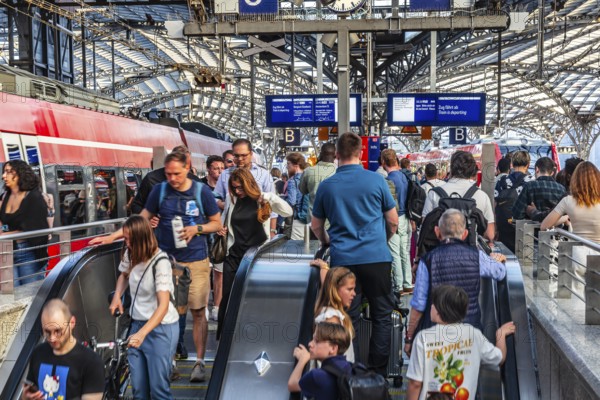 Cologne Central Station. Stairs to the platforms. Travellers waiting for their train on the platform. Crowd with motion blur. Cologne, North Rhine-Westphalia, Germany