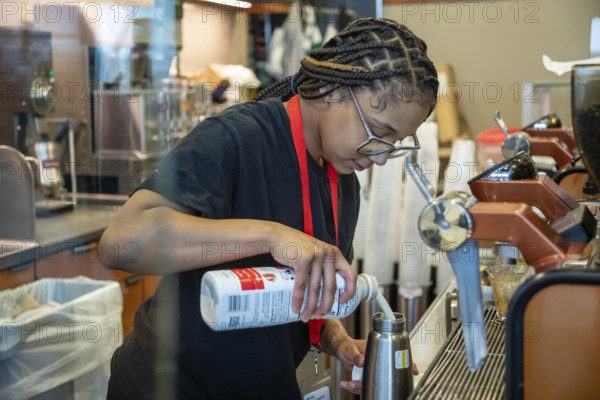 Detroit, Michigan - A young worker at a Starbucks coffee shop at Detroit Metro Airport