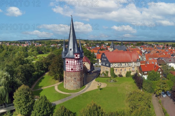 Aerial view, Junker Hansen Tower, fortified defence tower, residential tower, largest half-timbered round building in the world, height 51 metres, built in 1480, landmark of the town of Neustadt, to the right of Dörnberg Castle, late Gothic, built at the end of the 15th century, district of Marburg-Biedenkopf, Hesse, Germany