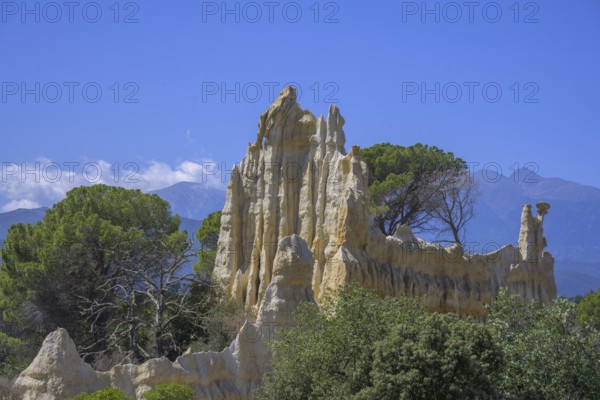 Sandstone cliff Les Orgues with Mount Canigou in the background, Ille-sur-Têt, Centre Ville Nord-Ouest, Département Pyrénées-Oriental, France