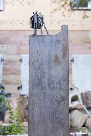 Bible verse on a metal plate with figures for charity, Cadolzburg, Bavaria, Germany
