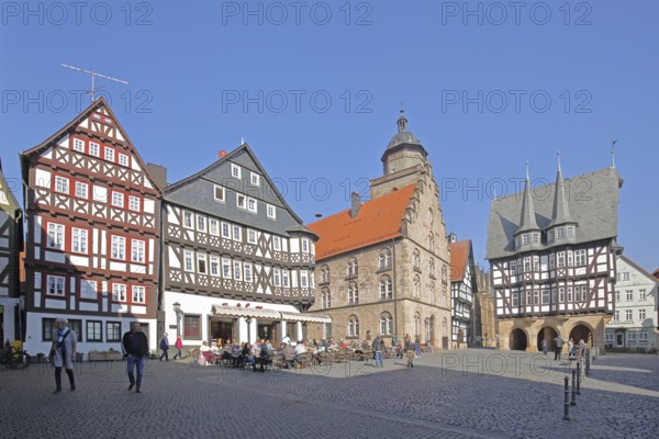 Historic Bücking House with street pub, Gothic Renaissance wine house built in 1539 and half-timbered town hall built in 1516 with turrets and decorations, church tower of the people, pedestrians, tourists, gastronomy, market square, Alsfeld, Vogelsberg, Hesse, Germany