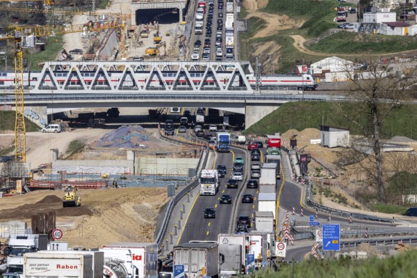Six-lane widening of the A8 motorway near Pforzheim. Enztal crossing construction site with heavy traffic and congestion. Railway bridge with Deutsche Bahn InterCity IC train. Niefern-Öschelbronn, Baden-Württemberg, Germany