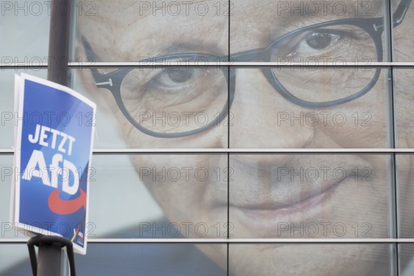 An election poster of the far-right AfD party (now AfD) hangs in front of a portrait of Friedrich Merz, the party chairman of the CDU, in front of the Konrad Adenauer House. Just after the 80th anniversary of the liberation of the Auschwitz concentration camp, the CDU chairman tabled a motion in favour of a tougher migration policy, which was only won thanks to the votes of the AfD. Berlin, 01.02.2025