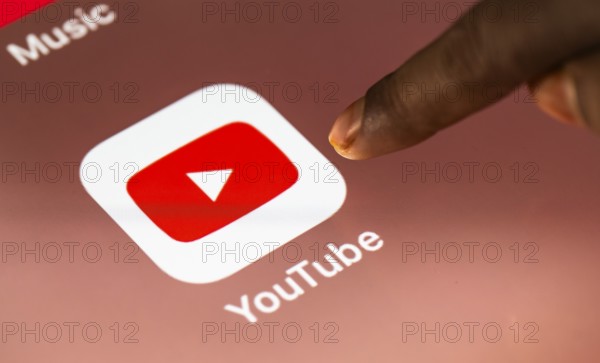 In this photo Illustration a person taps Googles Youtube application on a tablet device on 24 May 2025 in New Delhi, India