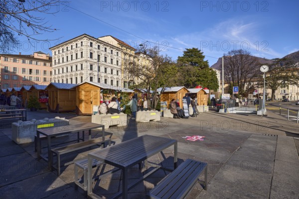 Christmas market in Piazza Manzoni square, Christmas stalls, market stands, outdoor area with tables and chairs, general architecture, trees, Riva Giocondo Albertolli street, Lugano, Lugano district, Ticino canton, Switzerland