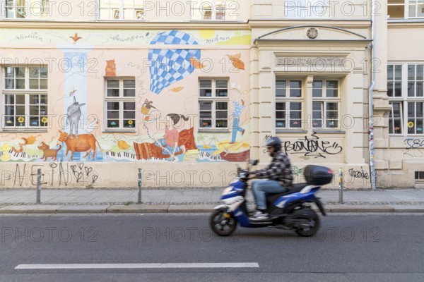 Colourful facade painting with motifs for children at the 15th primary school on Görlitzer Straße in Dresden, Saxony, Germany