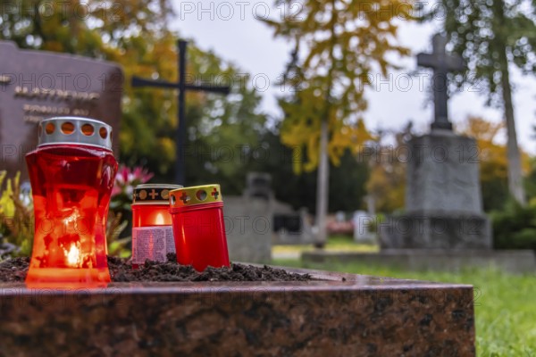 All Saints' Day at the Prague Cemetery in Stuttgart. Catholics commemorate their deceased relatives. Grave decorations and candles. Stuttgart, Baden-Württemberg, Germany
