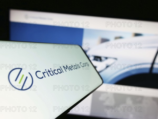 Stuttgart, Germany, 07-27-2023: Mobile phone with logo of lithium company Critical Metals Corp. on screen in front of business website. Focus on center-left of phone display