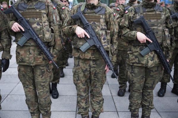 Polish army soldiers holding rifles on their bellies during roll call. Poland