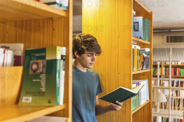 Teenager reading two bookcases