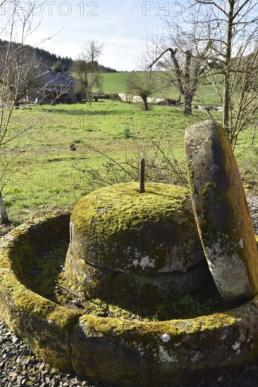 Old millstones in the national park community of Weiden near the Hunsrück-Hochwald National Park in Rhineland-Palatinate, Germany