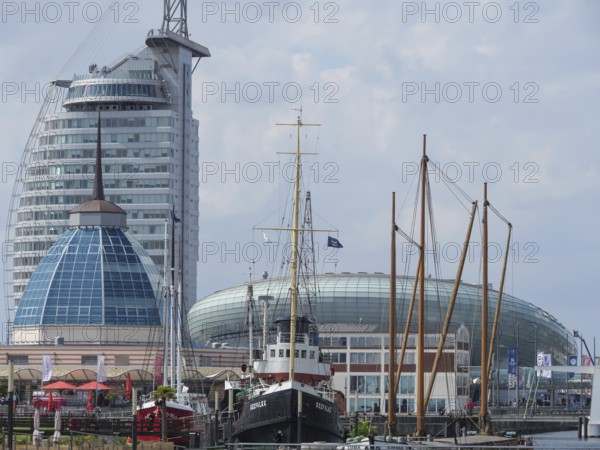 Ships and tall modern buildings in the harbour area under a cloudy sky, bremerhaven, bremen, germany