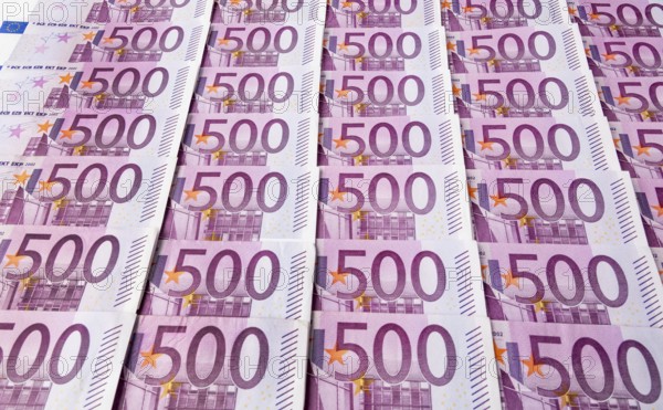 Many five hundred euro banknotes lying next to each other. Symbolic photo for wealth and investment Austria