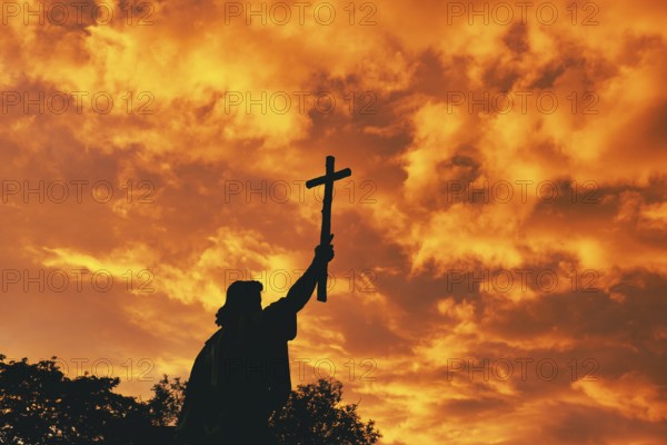 St Boniface statue at sunset, orange sky, Fulda, Germany