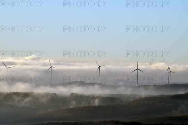View from the Wildenburger Kopf in the Hunsrück-Hochwald National Park of the Nahe region with wind turbines on a misty winter morning, Rhineland-Palatinate, Germany
