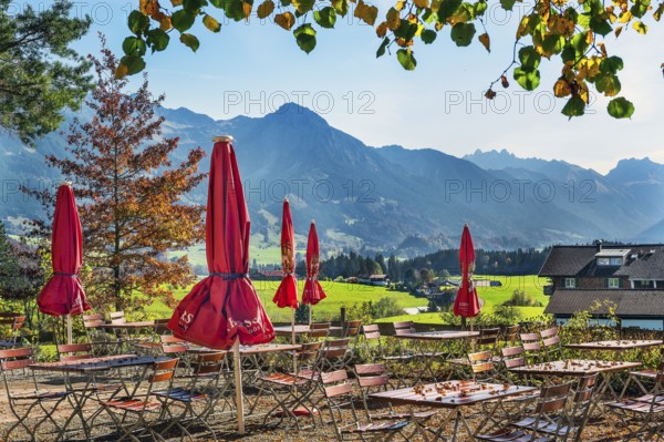 Autumn beer garden with parasols on the Schweineberg, Allgäu Alps near Ofterschwang, Allgäu, Bavaria, Germany