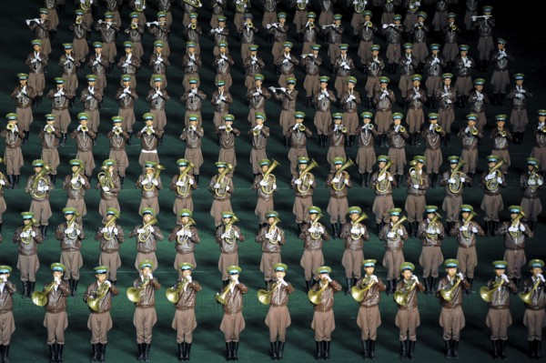 08.08.2012, Pyongyang, North Korea, Asia, A military band performs at the Arirang Festival at the Rungrado May Day Stadium in Pyongyang. The majority of the performances during the mass event are performed by rhythmic gymnastics dancers who have been trained and rehearsed for months in advance. An estimated 100, 000 dancers, acrobats and participants celebrate their patriotism and the socialist unity of the Juche ideology. The event takes place every year in the warm summer months from July to September