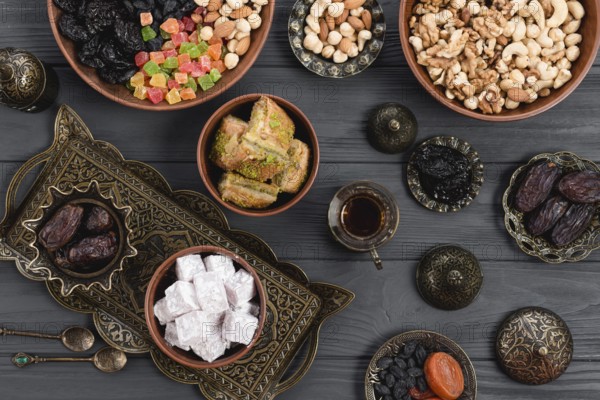 Homemade turkish delight baklava dates dried fruits nuts metallic earthen bowl table. High resolution photo
