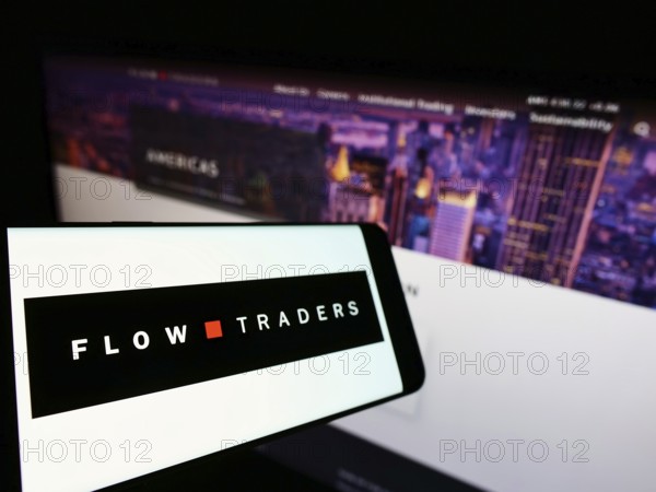 Stuttgart, Germany, 02-13-2022: Mobile phone with logo of Dutch financial company Flow Traders N.V. on screen in front of business website. Focus on center-left of phone display