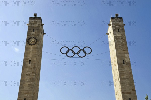 Berlin Olympic Stadium by architect Werner March 1936, reconstruction with roof construction by Gerkan, Marg and Partners 2004, Charlottenburg, Berlin, The entrance towers of the Berlin Olympic Stadium with Olympic rings in the blue sky, Berlin, Germany