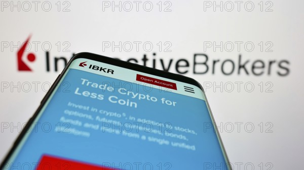 Stuttgart, Germany, 07-24-2022: Smartphone with website of US company Interactive Brokers LLC (IB) on screen in front of business logo. Focus on top-left of phone display