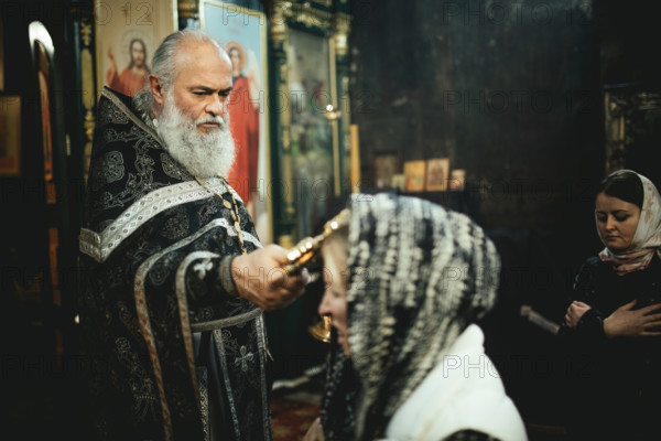 Exorcism during Sunday church service at Father Sergej's church outside of Ochamchira. Father Sergej is widely known as exorcist, people from all over Russia visit him to seek his help, Ochamchira, Abkhazia, Georgia