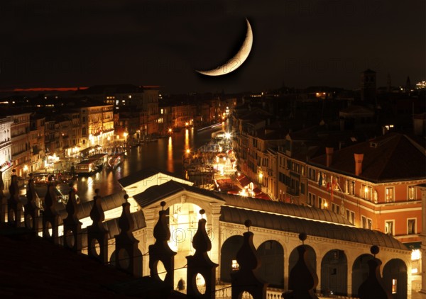 View from the Fondaco dei Tedeschi, with photomontage moon, to the Rialto Bridge and the Grand Canal, Venice, Veneto, Italy