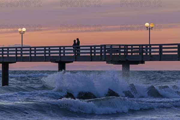 Sunset, pier, people, silhouettes, waves, swell, spray, street lamps, Wustrow, Fischland, Mecklenburg-Vorpommern, Germany
