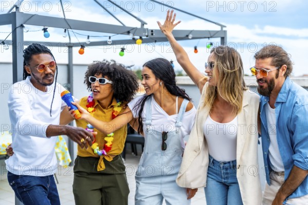 Group of diverse friends celebrating on a rooftop, singing karaoke, dancing joyfully, and enjoying a vibrant summer party together