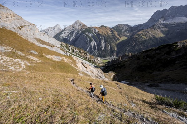 Mountain panorama with picturesque mountain landscape, mountaineers descending from the Gamsjoch, behind mountain peaks Sonnjoch and Schaufelspitze, in autumn, Rißtal in the Eng, Karwendel, Tyrol, Austria