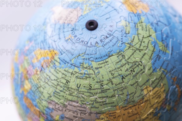 Puzzle globe. Map made from puzzle pieces. Russia and North Pole