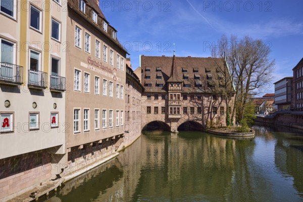 Heilig-Geist-Spital, historic hospital, pharmacy, river Pegnitz, historic buildings, facade, windows, trees, symmetrical reflections, water surface, blue sky, cirrostratus clouds, Nuremberg, Middle Franconia, independent city, Bavaria, Germany