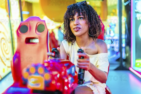 Young woman enjoying a car racing arcade game, holding the steering wheel and focused on the screen in a colorful, illuminated entertainment center
