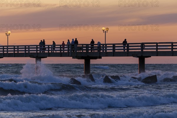 Sunset, pier, people, silhouettes, waves, swell, spray, street lamps, Wustrow, Fischland, Mecklenburg-Vorpommern, Germany