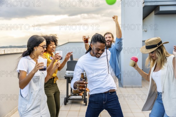 Young people enjoying a vibrant rooftop party, dancing, laughing, and sipping drinks while savoring delicious barbecue under the sunset sky