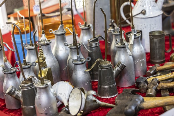 Used oil cans, oil spray cans for lubricating oil for vehicle maintenance. Vintage car trade fair Retro Classics in Stuttgart, Baden-Württemberg, Germany