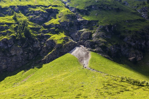 Waterfall and green slopes in a rock face, Zinal valley, Val d'Anniviers, Valais Alps, Canton Valais, Switzerland