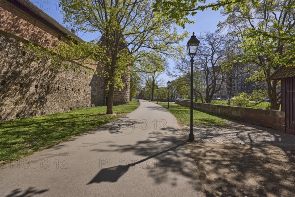 Old town, city fortification, city wall, footpath, trees, lawn, lantern, backlight, shadow, blue sky, cirrostratus clouds, Frauentor wall, Spittlertorzwinger, Nuremberg, Middle Franconia, independent city, Bavaria, Germany